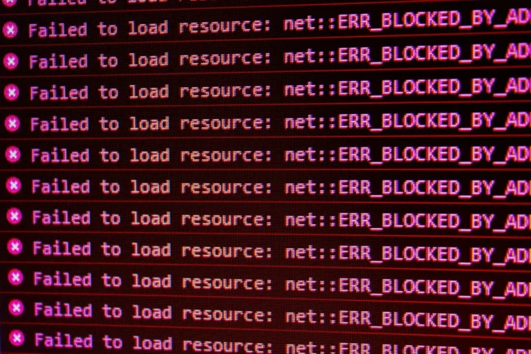 Red error messages on a black computer screen indicating blocked web resources