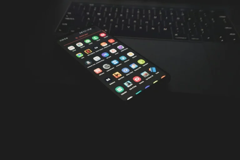 black iphone 5 on black computer keyboard